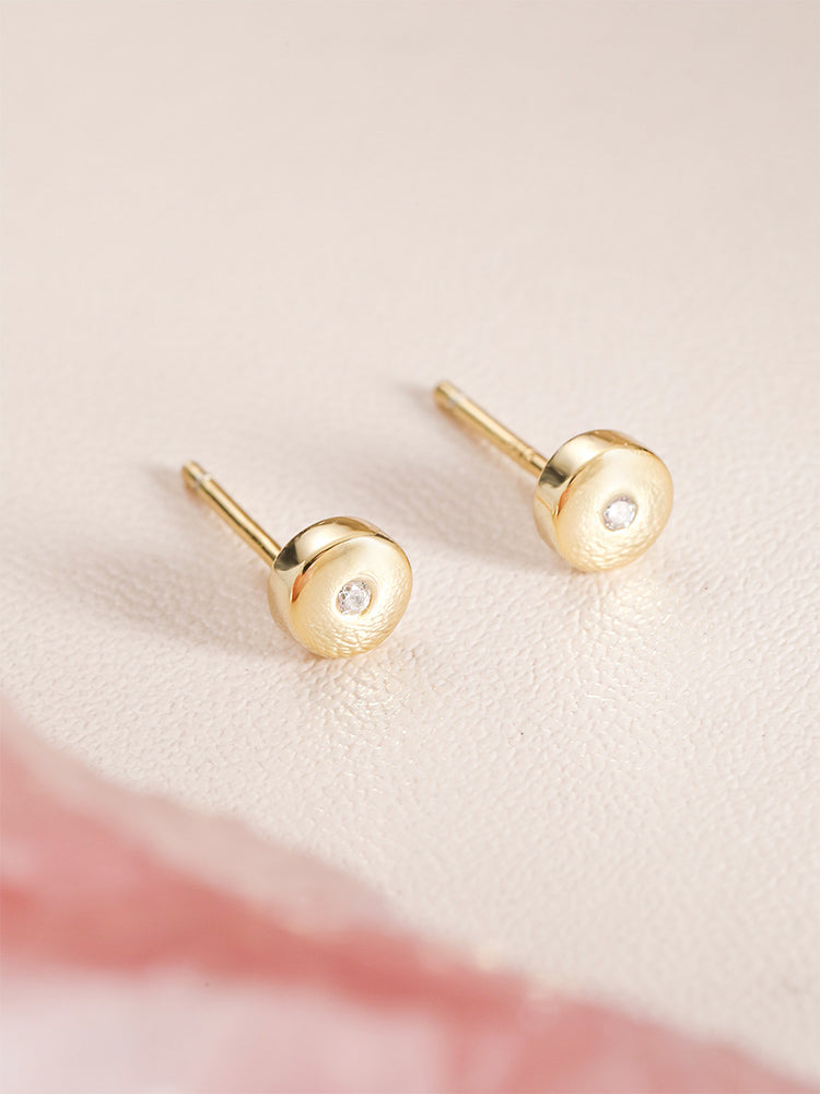 Tiny beanies with diamond stud earrings pierced